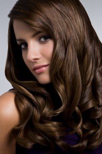 Young woman with shiny curly hair, portrait.
